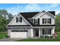 Charming two-story home with stone accents, a two-car garage, and a beautifully landscaped front yard at 368 Abingdon Farms Dr, Selma, NC 27576