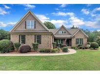 Charming brick home featuring a beautifully landscaped front yard and a mix of brick and shingle exterior at 3728 Marwick Ct, Wendell, NC 27591