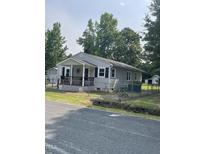 Charming single-story home with a covered front porch and fenced yard at 40 Bait Rd, Dunn, NC 28334