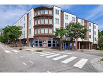 Brick building at 300 West Rosemary with street access, crosswalk, trees, and blue skies at 400 W Rosemary St # 114, Chapel Hill, NC 27516
