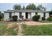 Charming single-story home with a brick facade and tidy landscaping at 620 Red Carriage Ave, Durham, NC 27704
