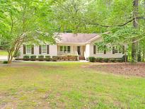 Charming single-story home with lush landscaping and a welcoming front porch at 637 Shadywood Ln, Raleigh, NC 27603