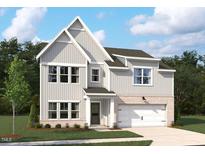 Charming two-story home with gray siding, brick accents, manicured lawn and attached two-car garage at 713 Compeer Way # 33, Wake Forest, NC 27587