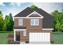 Charming brick two-story home with a two-car garage and a beautifully landscaped front yard at 807 Outlaw Ave # 19, Durham, NC 27703