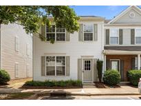 Charming townhome with a well-maintained lawn and neutral-colored siding and shutters at 8151 Rhiannon Rd, Raleigh, NC 27613