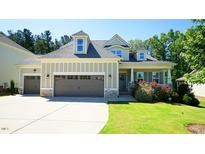 Charming home boasts a well-manicured lawn, attached garage, and welcoming entrance at 966 Airedale Trl, Garner, NC 27529