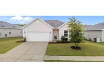 Charming one-story home featuring a well-maintained lawn, concrete driveway, and attached garage at 119 Yadkin St, Clayton, NC 27520