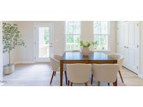 Bright dining room with natural light, featuring a wooden table and seating for six at 1359 Chowan Ave, Durham, NC 27713