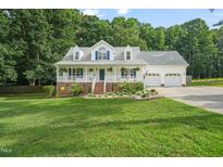 Charming two-story home featuring a spacious front porch and well-manicured lawn at 178 Palmer Dr, Clayton, NC 27527