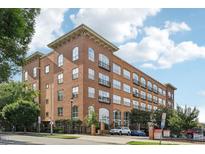 Beautiful brick condo building with large windows and small balconies at 200 S Dawson St # 114, Raleigh, NC 27601