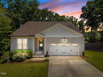 Charming single Gathering home featuring a manicured lawn and attached two car garage at 2321 Blue Crab Ct, Wake Forest, NC 27587