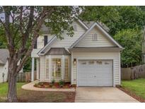 Charming home with a front yard, mature trees and an attached one car garage at 2409 Valley Haven Dr, Raleigh, NC 27603