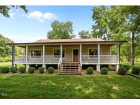 Inviting front exterior with a charming porch and well-manicured lawn at 3044 Rock Springs Church Rd, Creedmoor, NC 27522