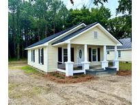 Charming single-story home with a welcoming front porch and classic black and white accents at 307 N Church St, Kenly, NC 27542