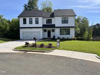 Charming two-story home with a well-manicured lawn and a two-car garage at 3204 Overlook Ct, Burlington, NC 27215