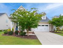 Charming home with a two-car garage and beautiful landscaping at 33 Village Walk Dr, Chapel Hill, NC 27517
