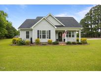 Charming single-story home with manicured lawn, tasteful landscaping, and an inviting covered porch at 416 Fred Tew Rd, Dunn, NC 28334