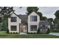 Striking two-story home boasts a brick facade, modern black-trimmed windows, and a welcoming entrance at 429 Shinleaf Pond Trl, Raleigh, NC 27614