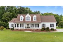 Charming single-Gathering home featuring a spacious front porch, dormer windows, and a well-manicured lawn at 541 Mallie Pearce Rd, Zebulon, NC 27597