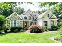 Charming home with stone accents, manicured lawn, and inviting front porch at 5920 Two Pines Trl, Wake Forest, NC 27587