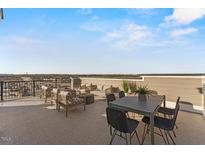 Inviting outdoor seating area featuring stylish patio furniture and distant views at 600 Hedrick Ridge Road # 310 209, Cary, NC 27519