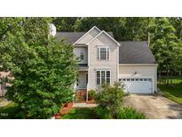 Charming two-story home featuring manicured landscaping and a welcoming front entrance and attached garage at 603 Everglades Dr, Mebane, NC 27302
