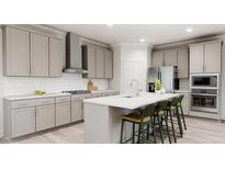 Modern kitchen with island, stainless steel appliances, and sleek gray cabinets at 713 Emerald Bay Cir # 834, Raleigh, NC 27529