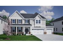 Charming two-story home featuring a three-car garage, covered front porch, and well-maintained landscaping at 75 Guardian St, Youngsville, NC 27596