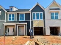 New townhomes featuring modern architecture, white-trimmed windows, and attached garages at 103 Ripple Way # 210, Clayton, NC 27520