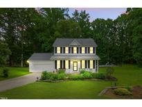 Charming two-story home with well-manicured lawn and inviting front porch perfect for relaxing at 3421 Kistler Ct, Willow Springs, NC 27592