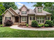 Charming exterior of a two-story home with stone accents, manicured landscaping, and a welcoming walkway at 512 Belmont Cir, Wake Forest, NC 27587
