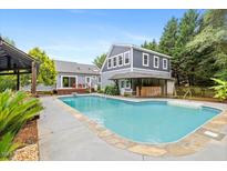 A stunning backyard oasis featuring a sparkling pool with a poolside bar, perfect for entertaining and relaxation at 7132 Deer Brook St, Willow Springs, NC 27592