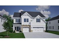 A charming two-story home with a three-car garage, landscaped yard, and a beautiful architectural design at 85 Guardian St, Youngsville, NC 27596