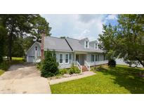 Charming home featuring a well-manicured lawn, dormer windows, and a welcoming entrance at 2016 Cypress Ct, Clayton, NC 27520