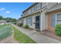 A charming townhouse featuring a well-maintained lawn and inviting front entrance at 2602 Hitchcock Dr, Durham, NC 27705