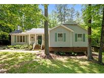 Charming single-Gathering home with green shutters surrounded by mature trees and landscaping at 3007 Appling Way, Durham, NC 27703