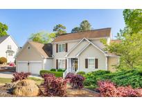 Charming two-story home with a well-manicured lawn and mature landscaping at 306 Neuse Ridge Dr, Clayton, NC 27527