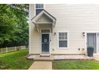 Charming two-story home with a welcoming front door and a landscaped yard at 320 Gilman Ln # 106, Raleigh, NC 27610
