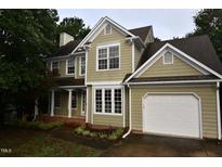 Charming two-story home featuring a two-car garage, manicured lawn, and neutral paint scheme at 3209 Leebrook Rd, Raleigh, NC 27616