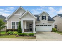 Charming single Gathering home with two-car garage, welcoming porch and manicured landscaping at 512 Courtship Cv, Durham, NC 27703