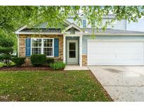 Charming two-story home with stone accents, light blue siding, and well-maintained landscaping at 518 Clearfield Dr, Durham, NC 27703