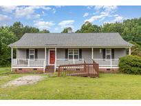 Charming single-story home with a welcoming front porch and accessible ramp at 6408 Glen Brack Ct, Raleigh, NC 27603