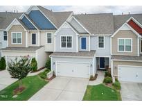 Charming townhouse featuring a two-car garage and well-maintained landscaping at 9 Moss Side Ter, Durham, NC 27703