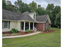 Charming home featuring a well-manicured lawn and beautifully landscaped front yard at 100 Deer Ridge Rd, Siler City, NC 27344