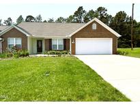Charming one-story brick home with a well-manicured lawn and inviting curb appeal at 106 Knight Ct, Graham, NC 27253