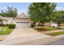 Charming home featuring a two-car garage, manicured lawn, and mature landscaping at 1104 Gaston Manor Dr, Durham, NC 27703