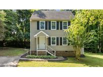 Charming two-story home featuring a landscaped front yard and welcoming front entrance at 113 Fox Run, Henderson, NC 27536
