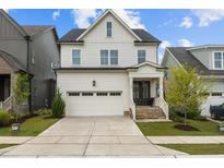 Charming two-story home with a well-manicured lawn and an attached two-car garage at 140 Big Barn Dr, Wendell, NC 27591