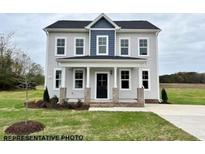 Charming two-story home with a covered front porch and craftsman-style details at 242 Waterwheel Dr, Selma, NC 27576