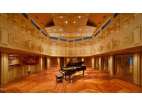 This music room is fully equipped with a grand piano, sound-engineered walls, and paneled ceiling at 2540 Seaforth Rd, Pittsboro, NC 27312